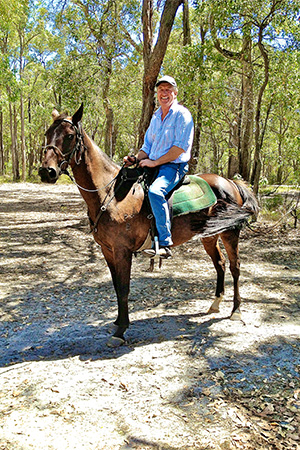 Photograph of a man riding a horse