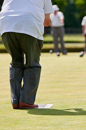 Photograph of people playing lawn bowls.