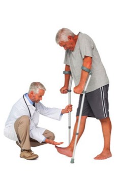 Photo of a doctor examining a man on crutches